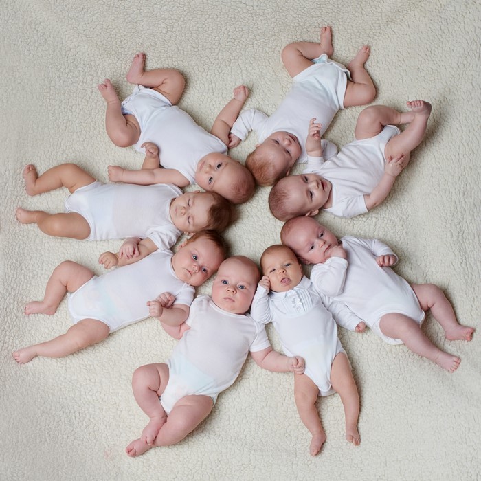 Many Infants in White Onesies