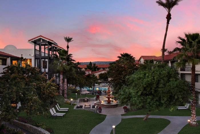 Resort courtyard with fountain at sunset in Palm Desert, California