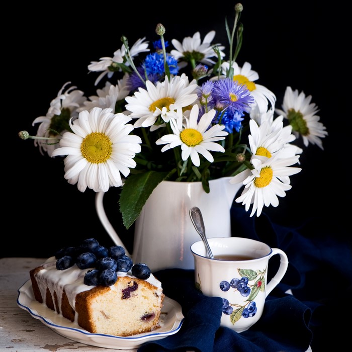 Still life with cake, tea, and flowers