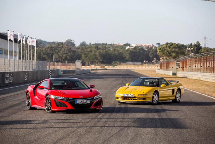 Two Honda NSX cars on a racetrack