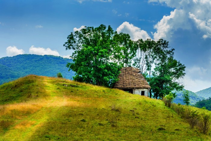 Old house on a grassy hill in Romania