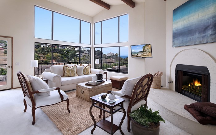 Living room with fireplace, sofa, and chairs