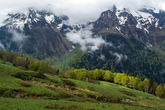 Snow-capped mountains and green hills in Arro, Catalonia, Spain