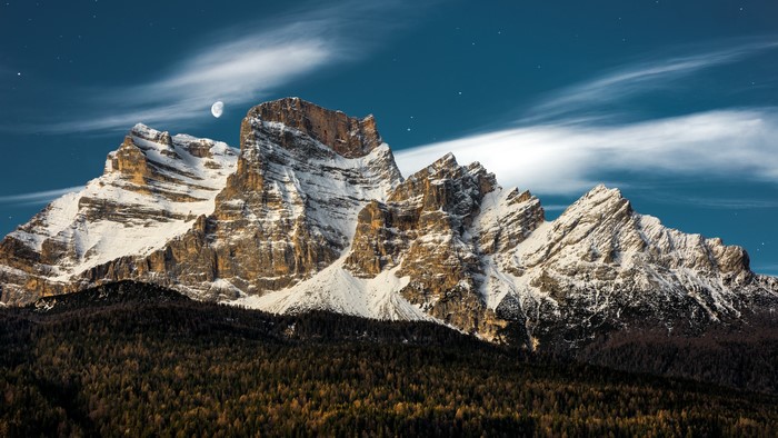 Snow-capped mountains in Italy under a starry sky