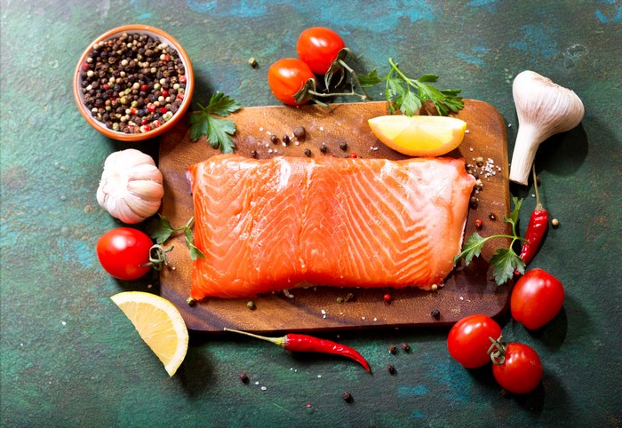 Salmon fillet with tomatoes, garlic, lemon, and spices