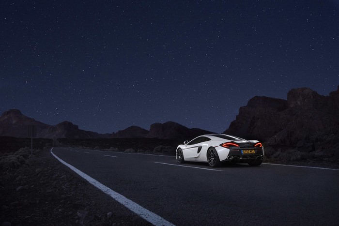 White McLaren 570GT on a road at night