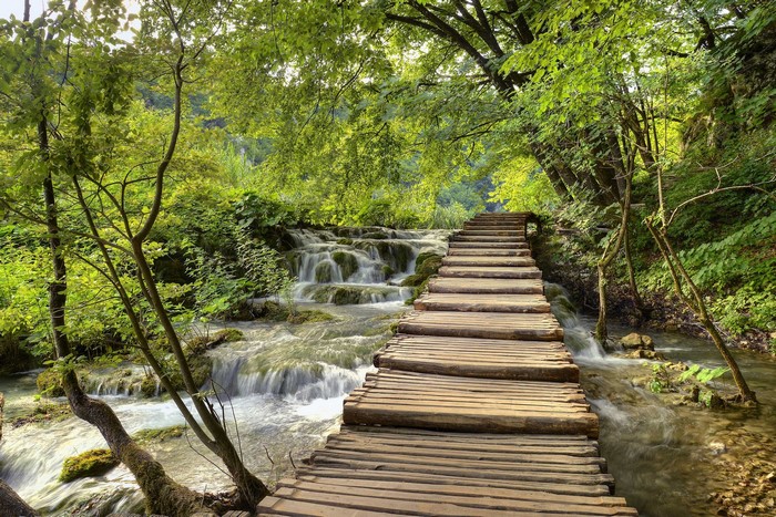 Wooden boardwalk along waterfalls in Plitvice Lakes National Park, Croatia