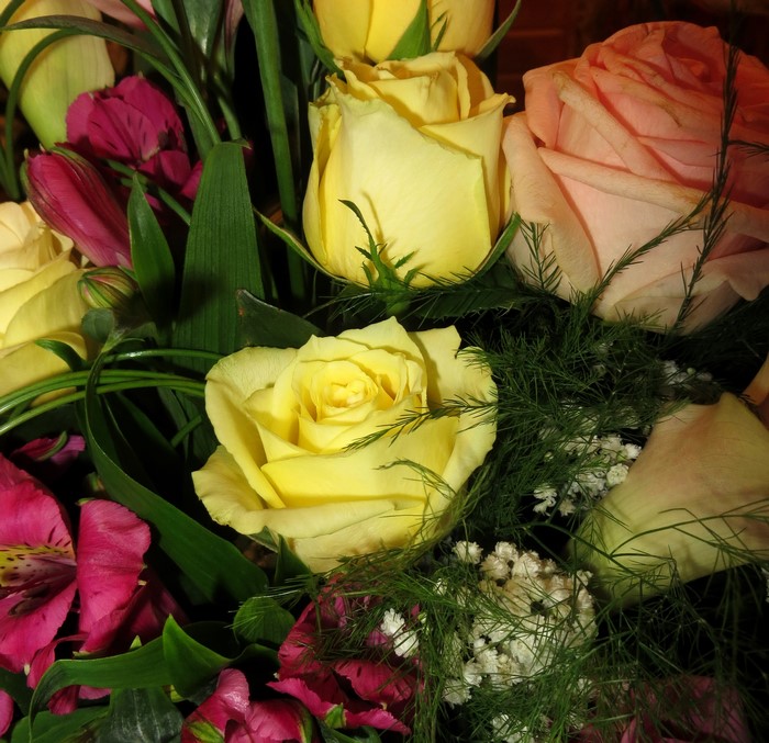 Yellow and pink roses with purple flowers