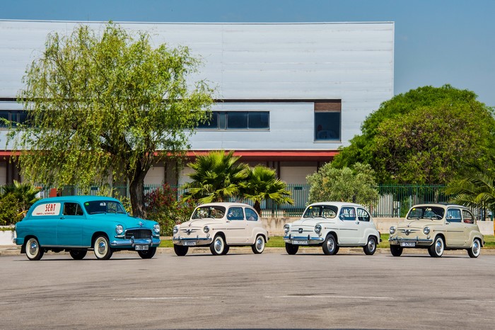 Four Seat cars in front of a building