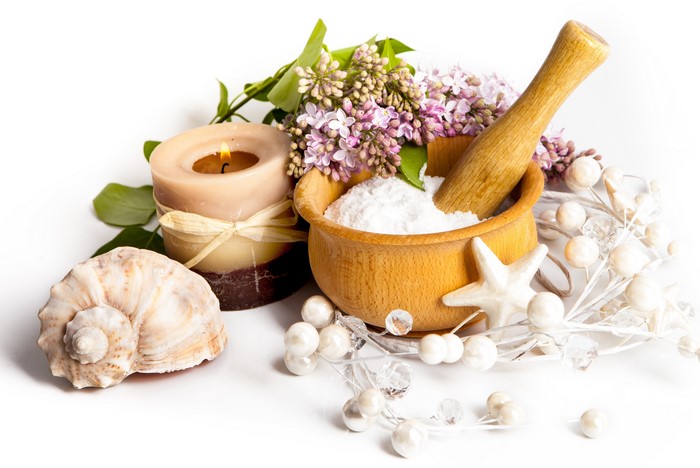 Spa arrangement with candle, shells, and lilac