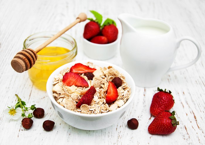 Muesli with strawberries, honey, and milk