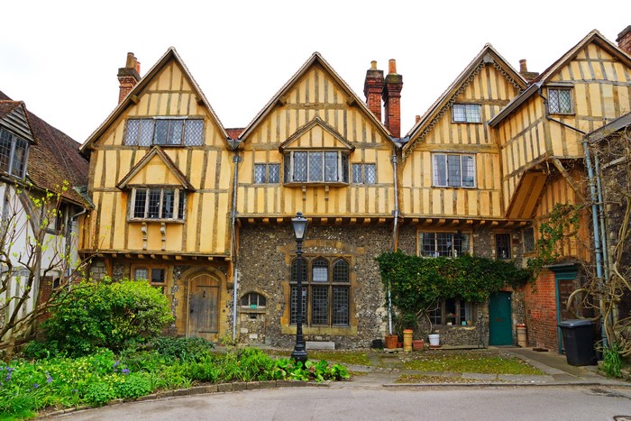 Timber-framed houses with shrubs and street lights in Winchester, England
