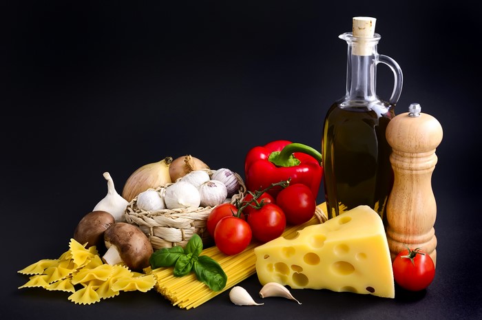 Still-life of Italian ingredients with pasta and cheese