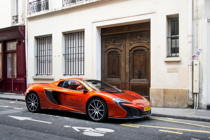Orange McLaren 650S Spider parked on street