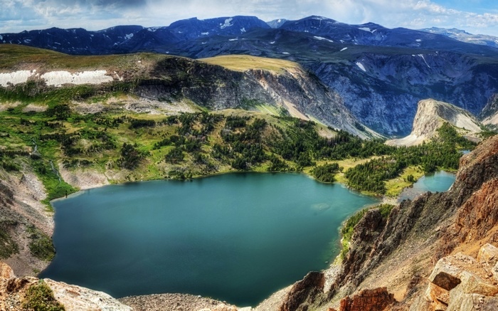 Mountain lake with surrounding peaks and trees