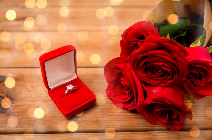 Red roses and diamond ring in a box