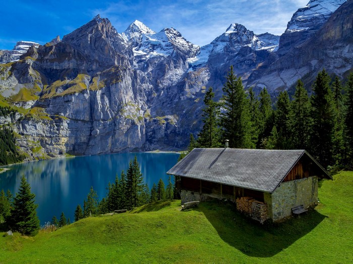 Cabin by a lake in the Swiss Alps