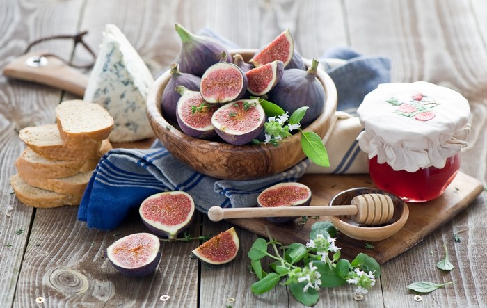 Figs, Cheese, Bread, and Jam on a Wooden Table