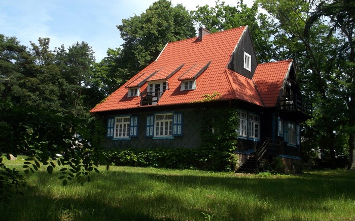 House with red roof surrounded by trees in Jastrzebia Gora, Poland