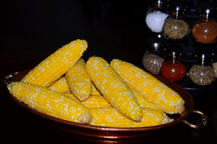 Corn in a bowl with spice rack
