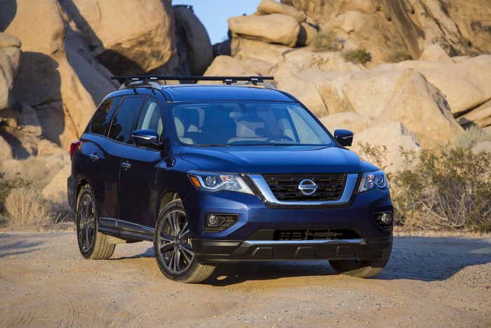 Blue Nissan Pathfinder SUV in desert landscape