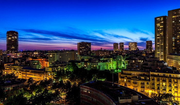 Paris skyline at dusk with illuminated buildings