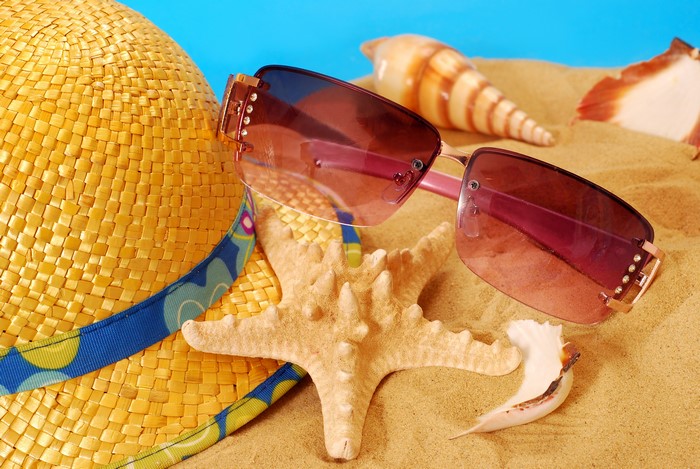 Starfish, Sunglasses, Hat, and Seashells on Sand
