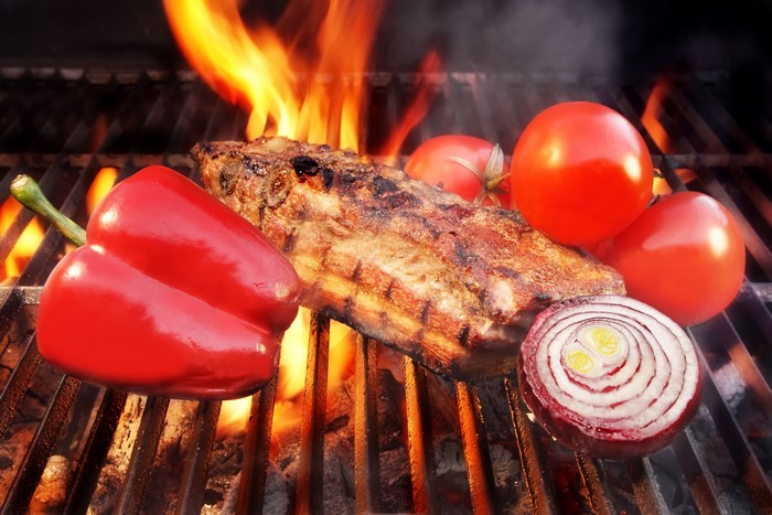 Meat, Bell Pepper, Tomatoes, and Onion on Grill with Fire