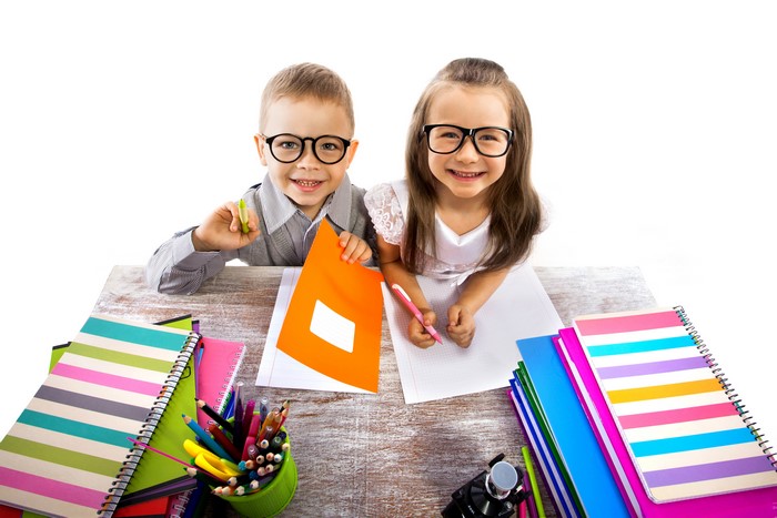 Two Children with Glasses and School Supplies