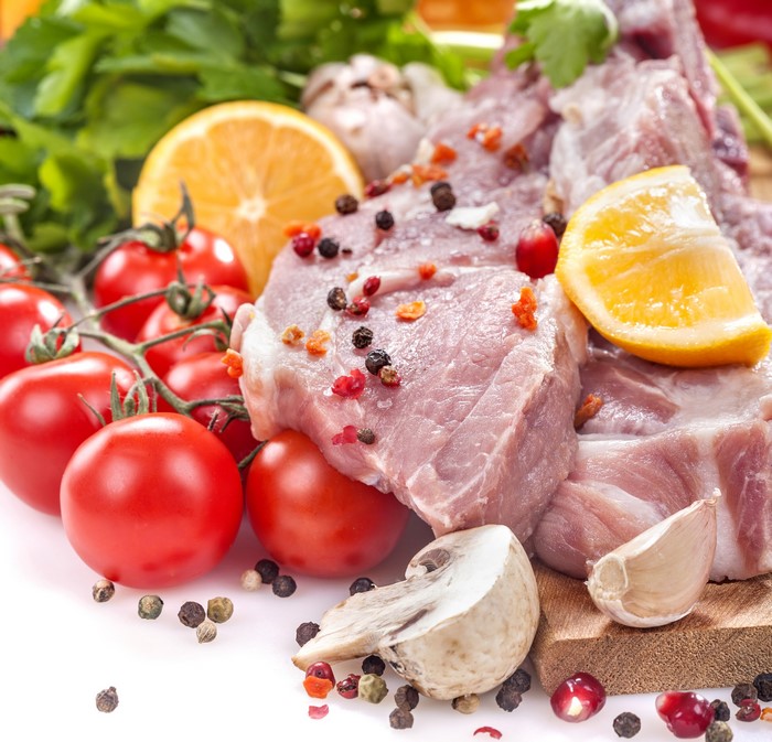 Raw meat with tomatoes, garlic, orange, and spices