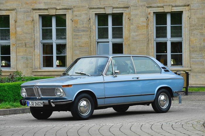 Light Blue BMW 1802 Touring parked in front of building
