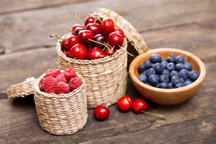 Cherries, Blueberries, and Raspberries in Wicker Baskets