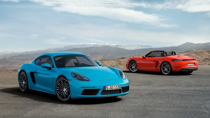 Two Porsche 718 Cayman S cars on a road