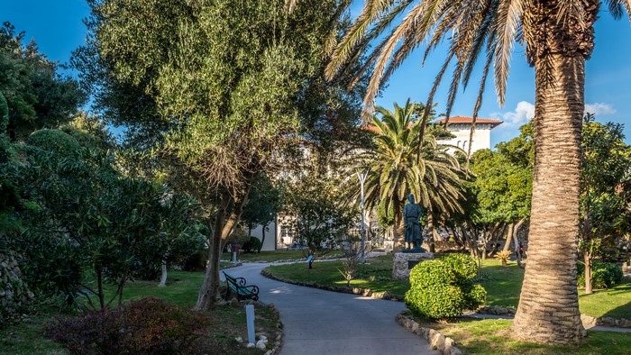 Park with statue and palm trees in Croatia