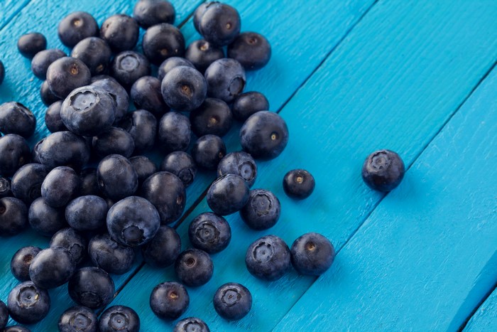 Blueberries on blue wood planks