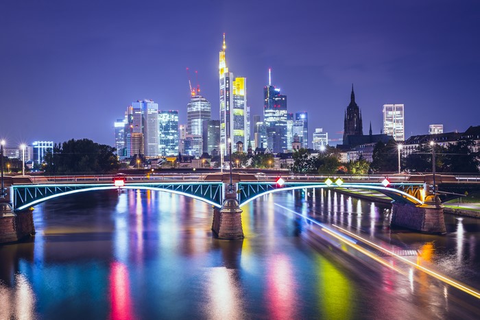 Frankfurt skyline with bridge over river at night
