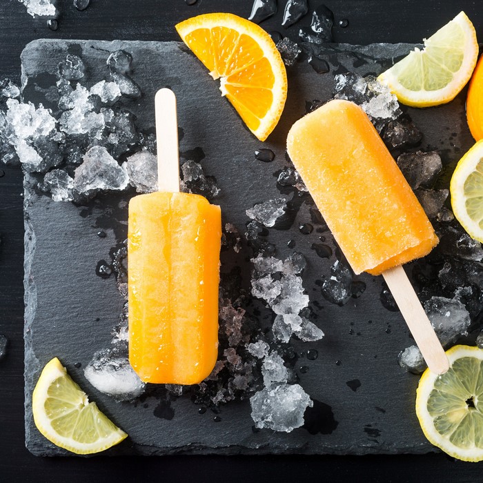 Orange popsicles with ice and citrus slices