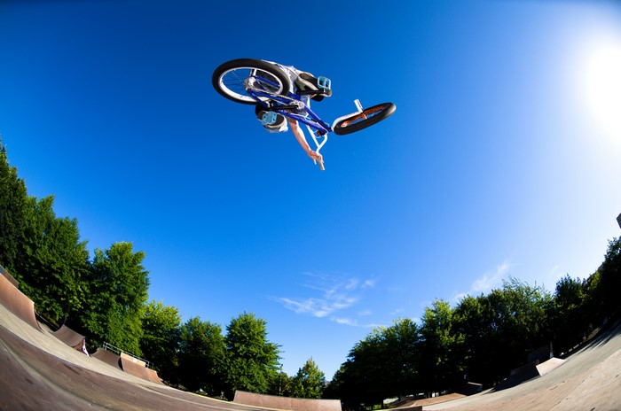 BMX rider performing a jump at a skatepark