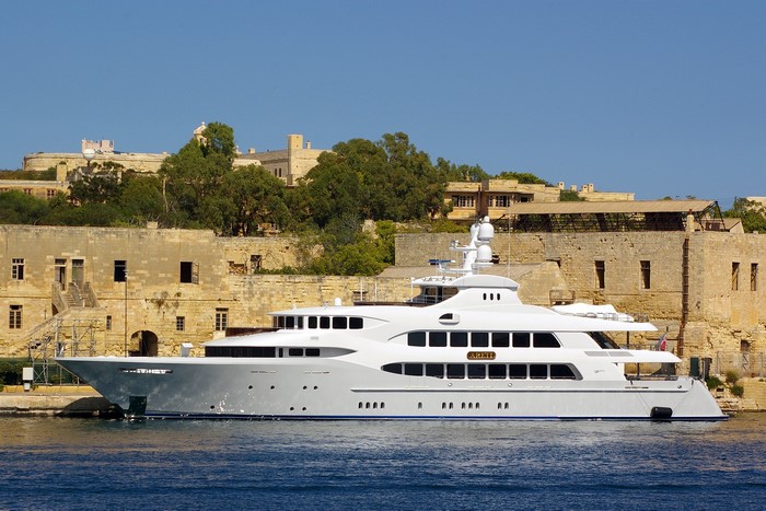 Superyacht Areti docked near historic buildings