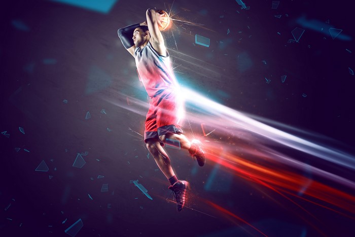 Basketball player jumping with ball