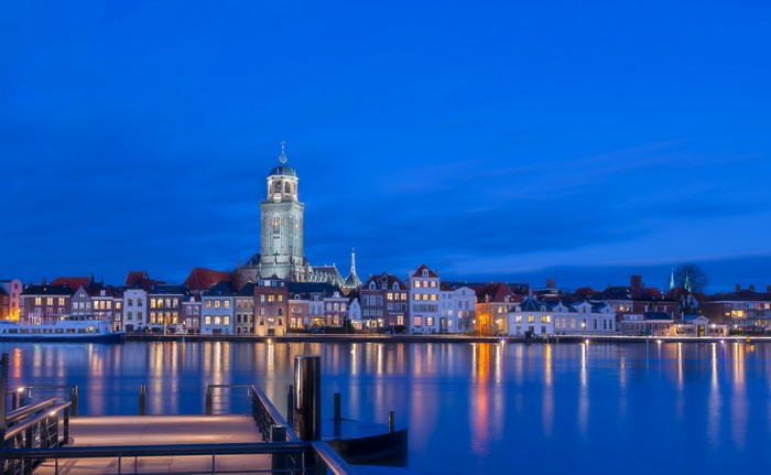 Deventer skyline with river and pier at night