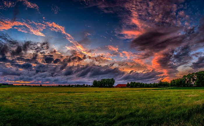 Dutch countryside with dramatic sunset sky over fields