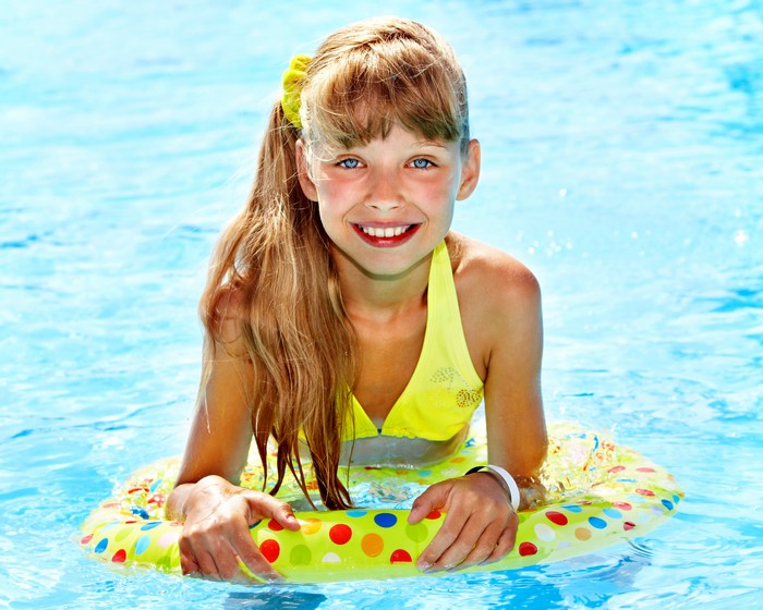 Smiling Brown-Haired Girl in Pool with Inflatable Ring 4K