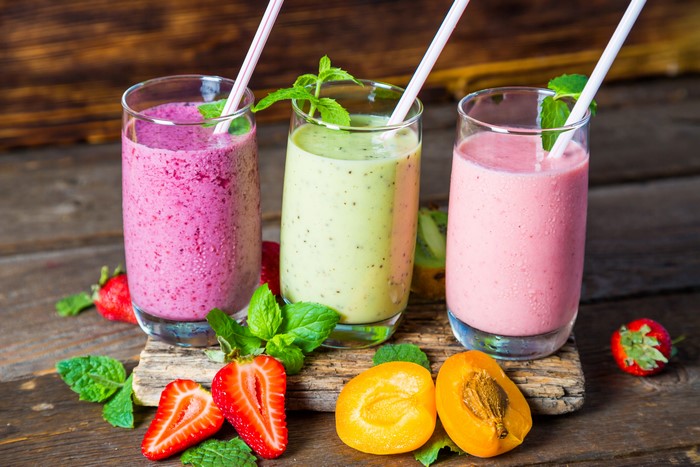 Three colorful fruit smoothies with strawberries and apricots