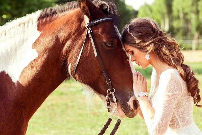 Woman in white dress with horse