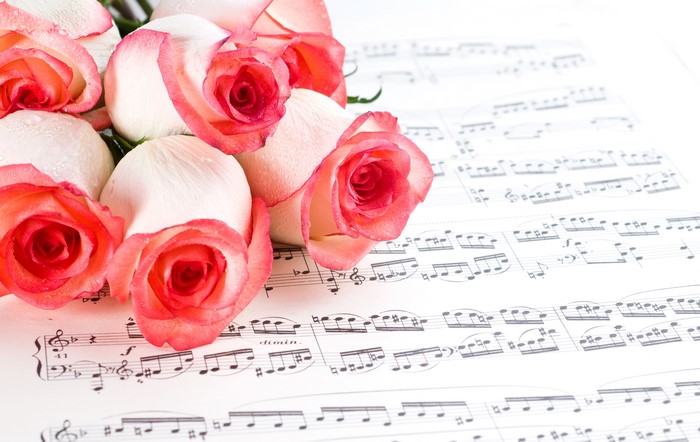 Pink and white roses on sheet music