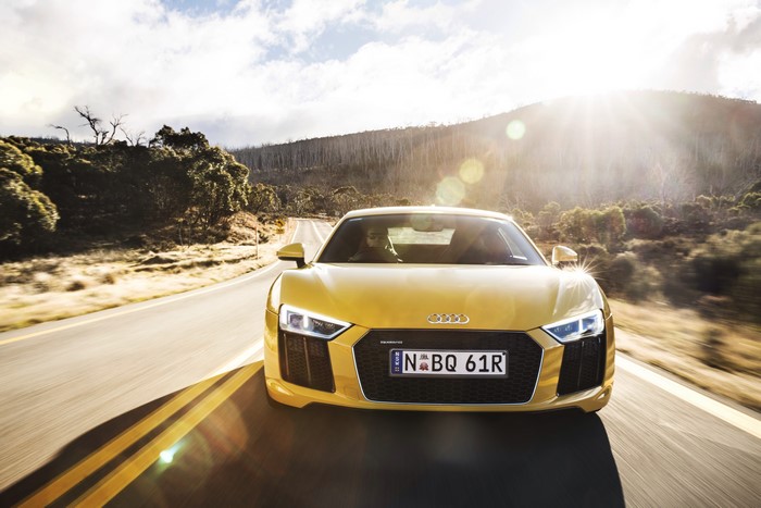 Yellow Audi R8 V10 driving on a road