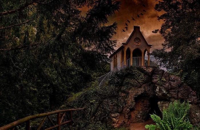 Chapel on a rocky crag with trees and birds