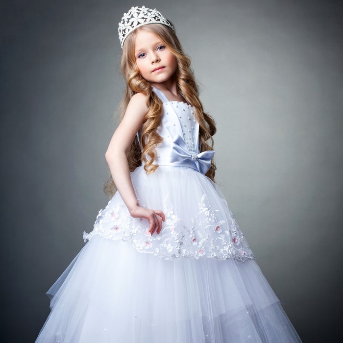 Young girl in a white princess dress and tiara