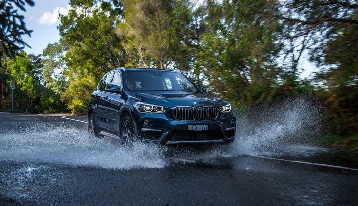 BMW X1 sDrive20i xLine driving through water splash